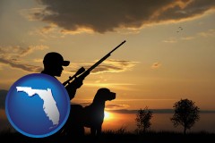 florida map icon and a hunter and a dog at sunset