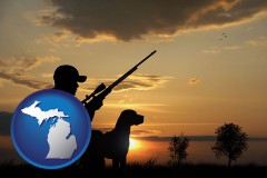 michigan map icon and a hunter and a dog at sunset