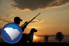 south-carolina map icon and a hunter and a dog at sunset