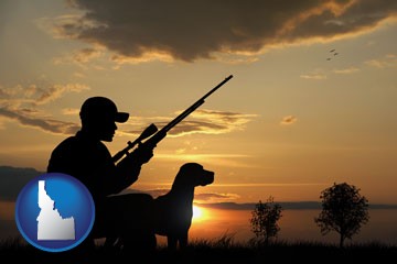 a hunter and a dog at sunset - with Idaho icon